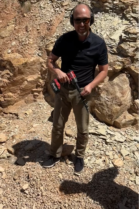 Man holding a Soundstake in a rocky outdoor setting