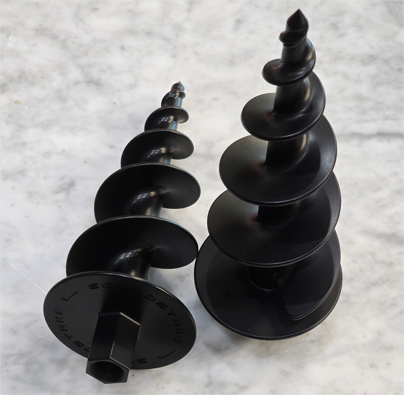 Two black SoundStakes on a marble surface